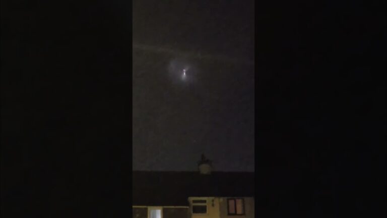 Glowing UFO Hovers in the Night Sky over UK Neighborhood